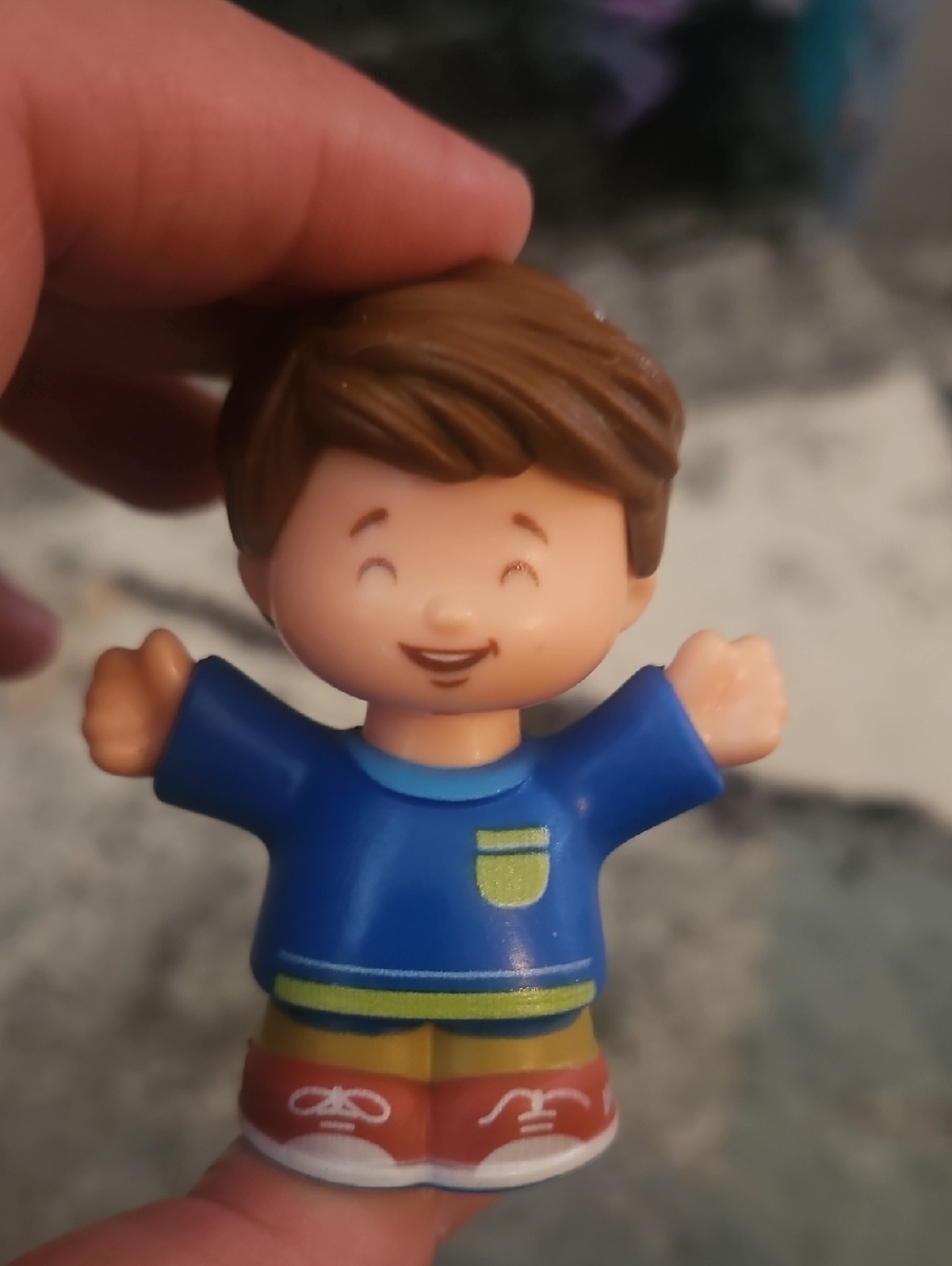 Fisher-Price Little People Jack figure wearing a blue shirt with brown hair.